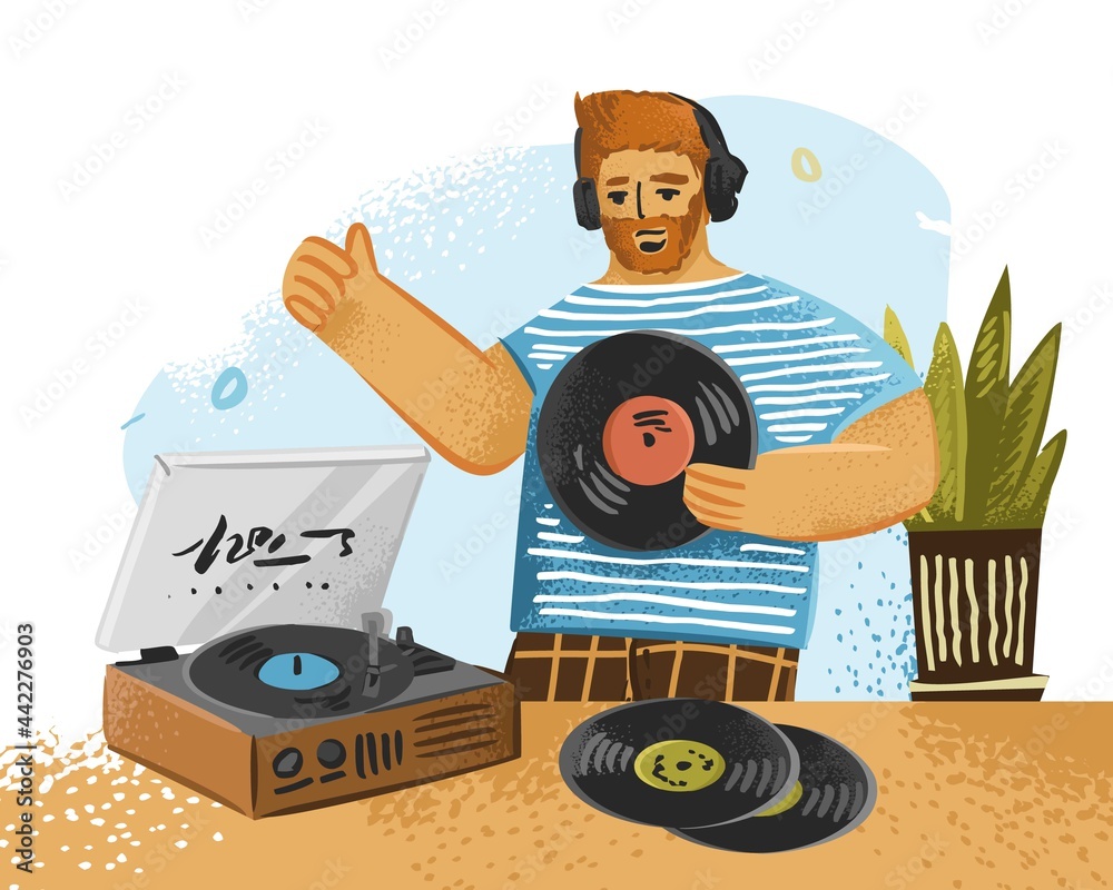 Boy with headphones is listening to music and holding a vinyl record in ...