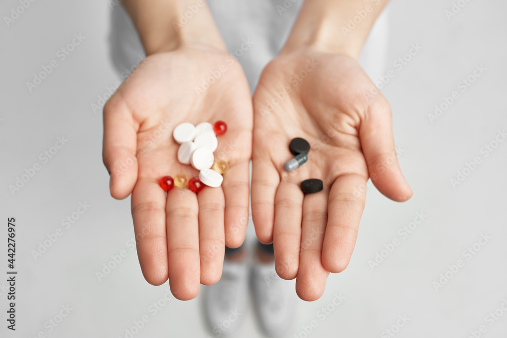 multicolored pills on palms close-up treatment medicine health