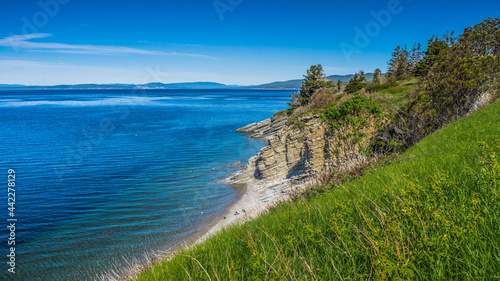 View on the cliffs and the Atlantic ocean on a beautiful summer day while hiking  Les Graves  trail in Forillon National Park near Gasp    Quebec  Canada 