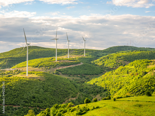 field and wind turbines, near coronini, romania, banat region photo