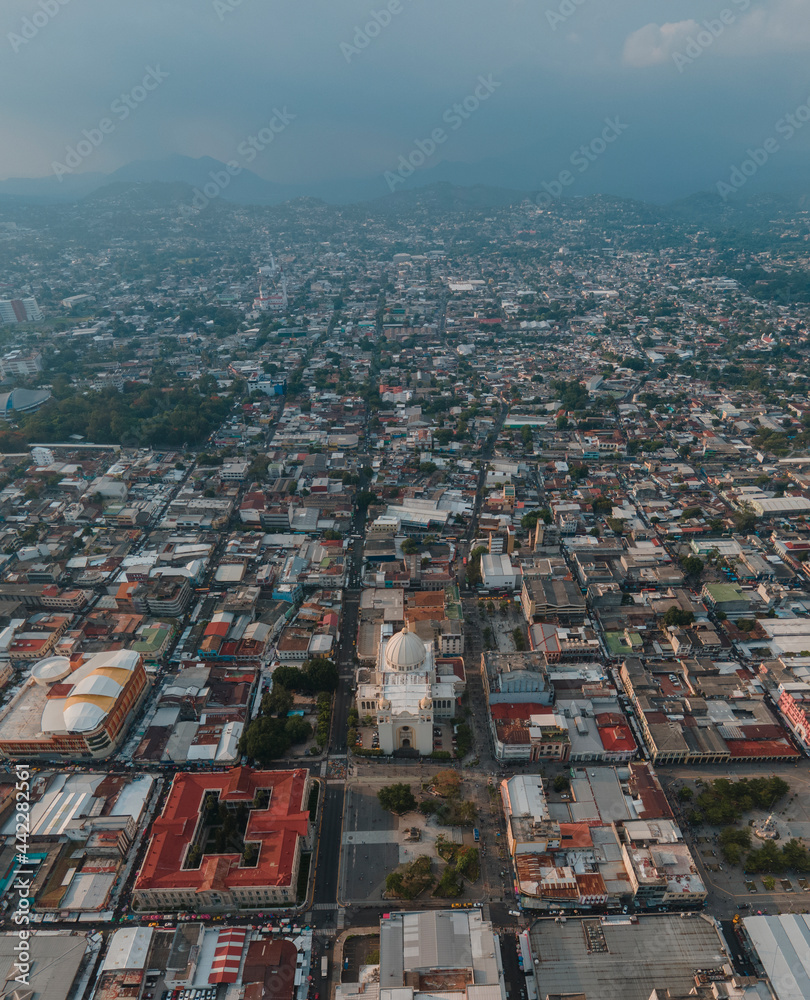 aerial view of san salvador by day, with the capital's cathedral in the center
