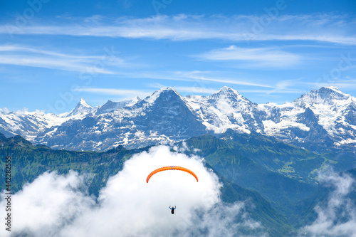 paraglide flyer in the Bernese Alps in front of Eiger Mönch and Jungfrau