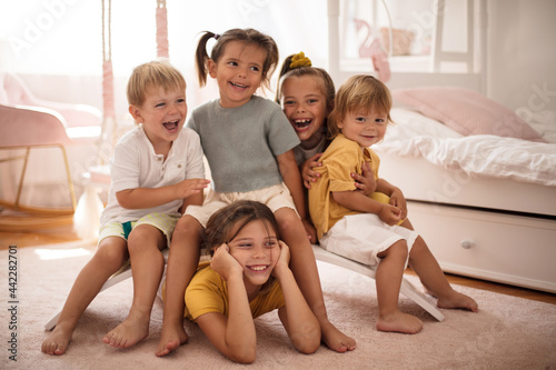 Group of happy kids in bedroom.