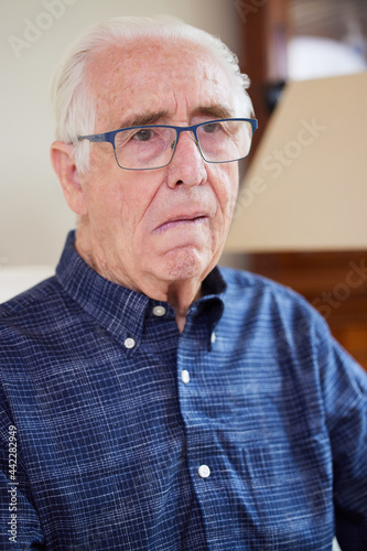 Photography Portrait Of Senior Man At Home Suffering From Stroke Showing Dropped Side Of Fac