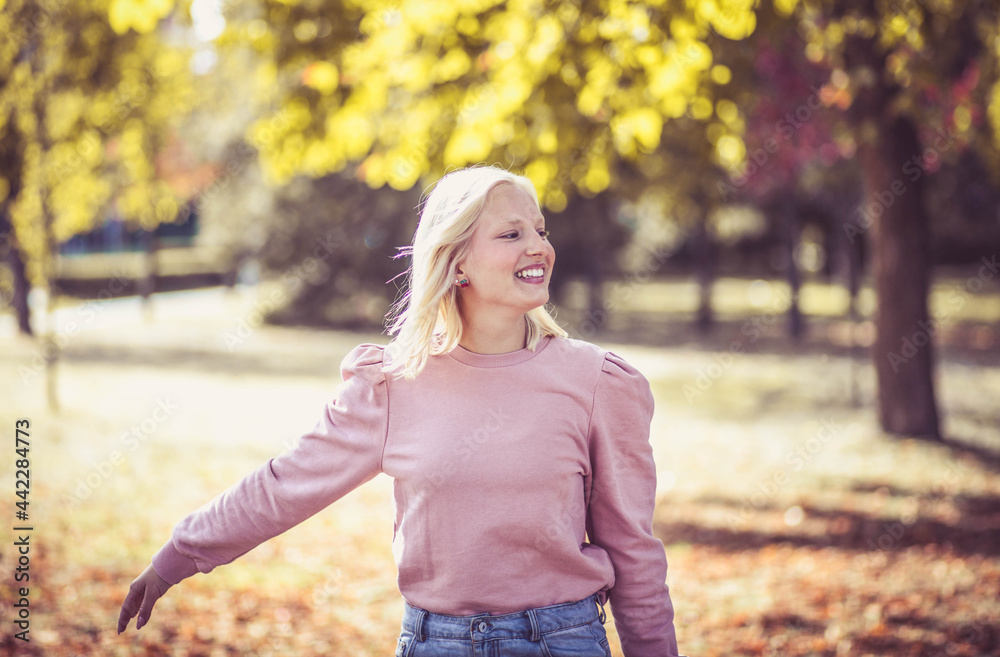 Happy young woman enjoying in the park. Walk trough nature. Happy young woman enjoying in the park. Walk trough nature.