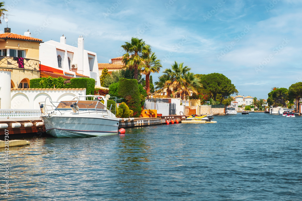 Obraz premium Beautiful and cozy resort town, Empuriabrava town in summer atmosphere, canal with yachts and small boats, Costa Brava, Catalonia