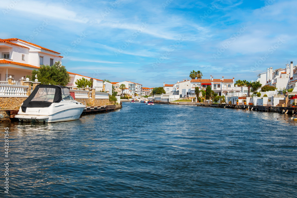 Beautiful and cozy resort town, Empuriabrava town in summer atmosphere, canal with yachts and small boats, Costa Brava, Catalonia