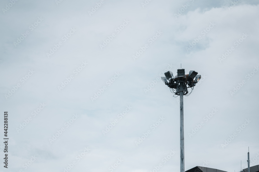 Several tall poles of spotlights against the backdrop of the sky. Several tall poles of spotlights against the backdrop of the sky.