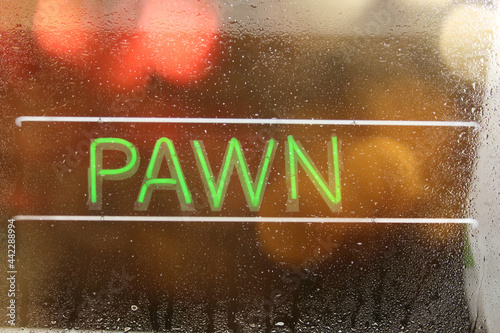 Vintage Neon Sign in Window of Pawn Shop photo