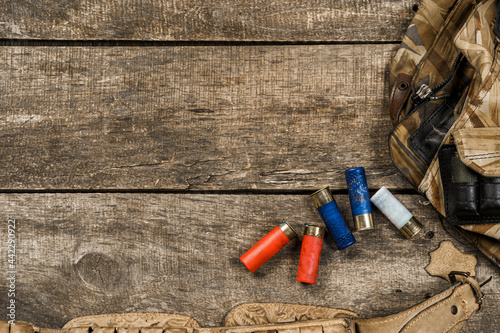 Various hunting equipment on old wooden background