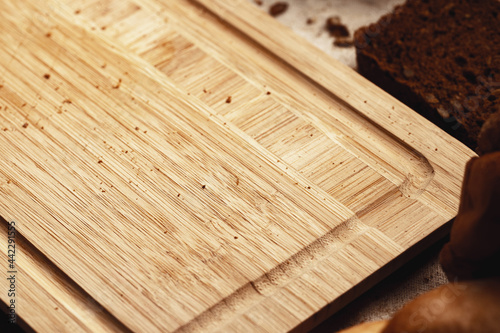 Wooden board with bread crumbs close up