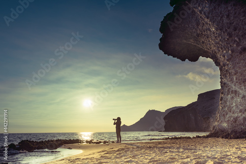 Woman with camera on Monsul beach, Spain photo