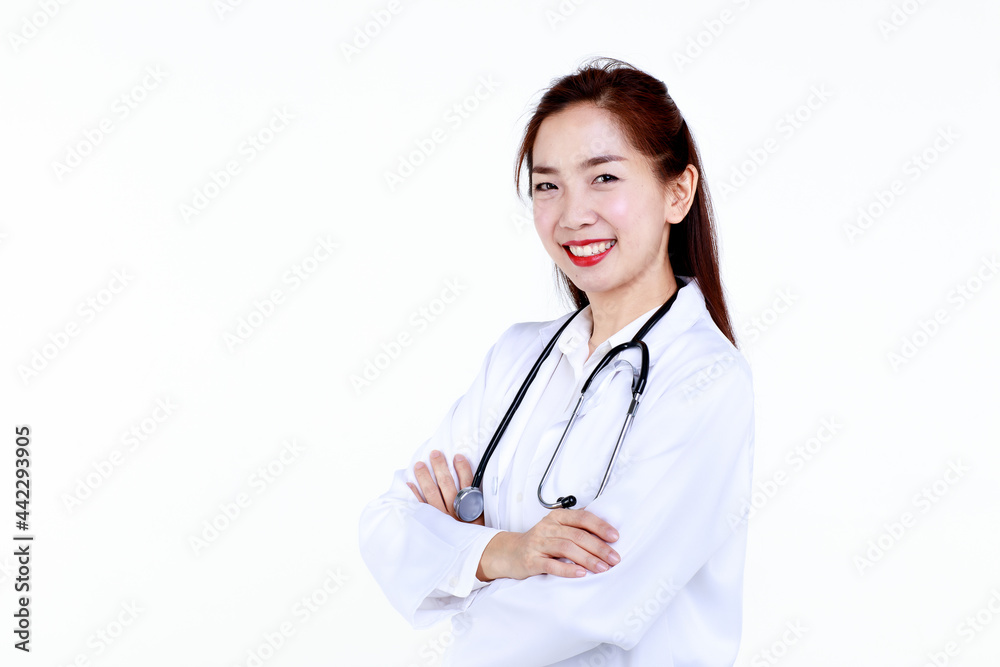 Competent young Asian female medical practitioner in uniform with stethoscope smiling friendly and looking at camera against white background.