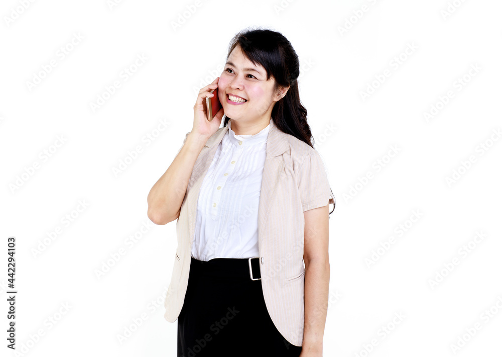 Happy young Asian office employee in elegant clothes using app on mobile phone against white background Happy young Asian office employee in elegant clothes using app on mobile phone against white background