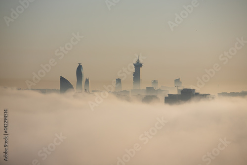 The tops of buildings peek out from the fog. Baku city. Azerbaijan.