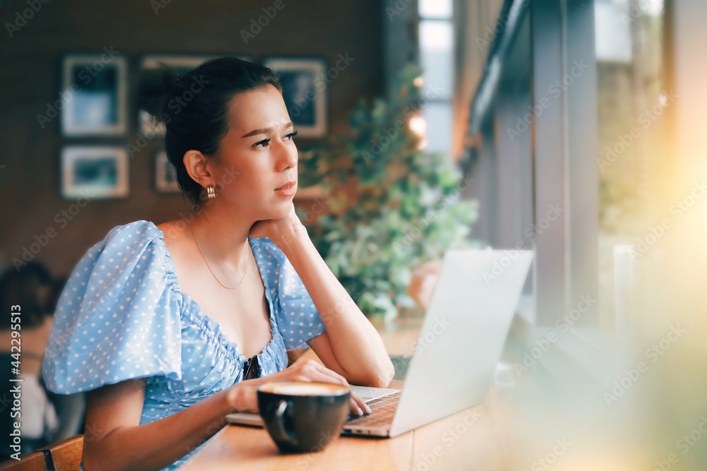 woman using laptop in cafe