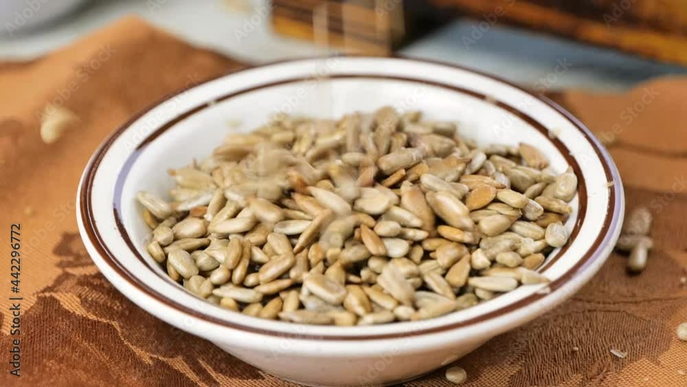 Pouring shelled sunflower seeds into a bowl super slow motion Pouring shelled sunflower seeds into a bowl super slow motion