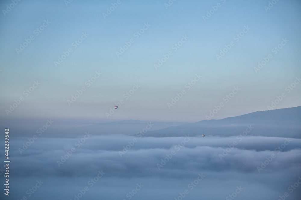 minimal balloon above mountain and cloud