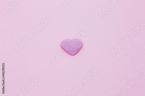Pink heart on pink background. Saint Valentine's day concept. Love and romantic photo. Postcard for holiday. Beautiful warm wallpaper with love. Soft focus. Copy space.