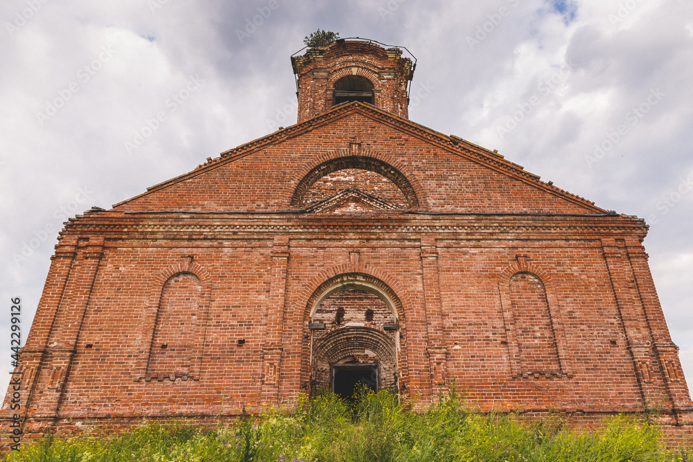 the old building of an abandoned orthodox church built of red brick gradually collapses without people