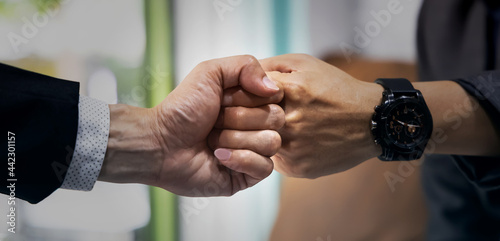 Banner of Business partnership  giving fist bump for sucessful of work in the office photo