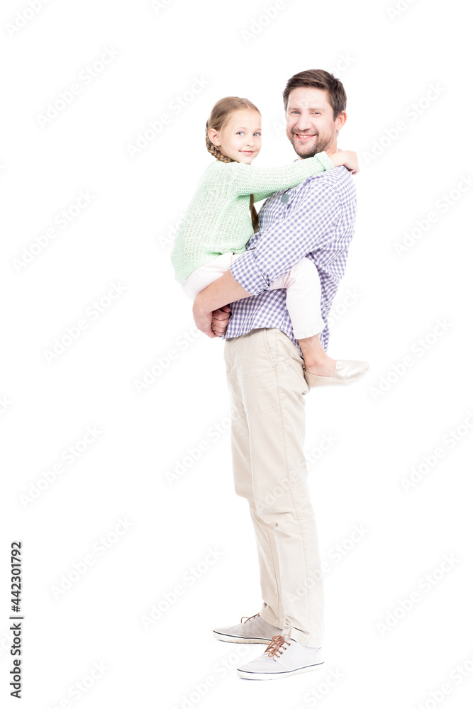 Vertical full length isolated shot of loving father wearing casual clothes holding his cute daughter in arms, white background