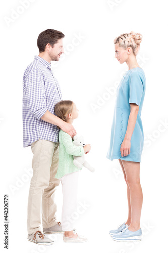 Wallpaper Mural Vertical full length shot of little girl standing with her father and mother watching them quarrelling about something, white background Torontodigital.ca