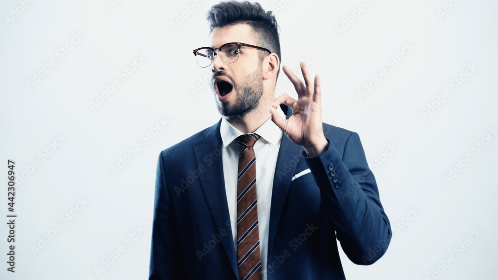 excited businessman with open mouth showing okay gesture isolated on white excited businessman with open mouth showing okay gesture isolated on white