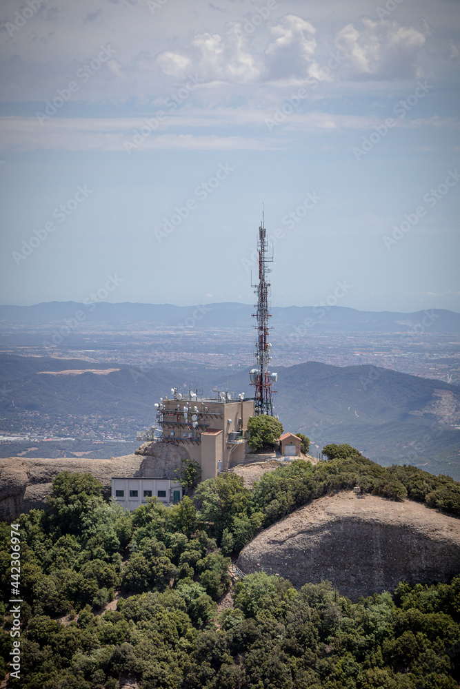 Cell tower (Base station or base radio station) on the top of Montserrat, Mountain, Catalonia, Spain. View from above. Aerial view.