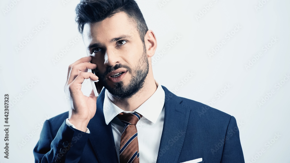 thoughtful businessman talking on mobile phone isolated on white thoughtful businessman talking on mobile phone isolated on white