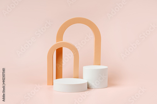 Abstract background with geometric forms and podiums in pastel color for product presentation. Podium and arch  to show cosmetic products. photo