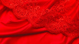 Tailoring concept. beautiful red guipure fabric with satin fabric Top view. Texture. Background