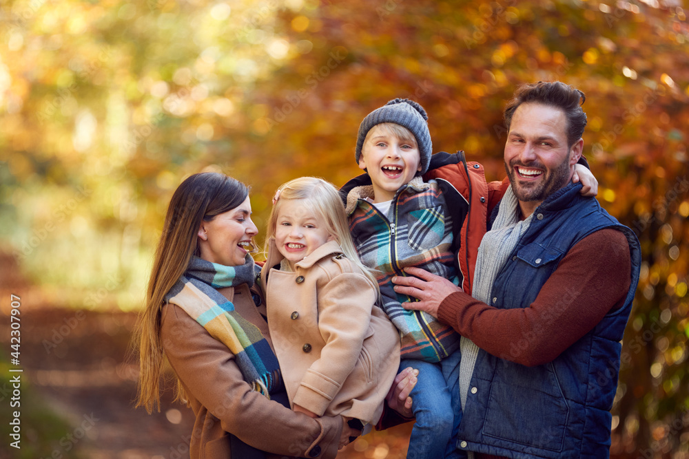 Portrait Of Family With Mature Parents And Two Children Walking Along Track In Autumn Countryside Portrait Of Family With Mature Parents And Two Children Walking Along Track In Autumn Countryside