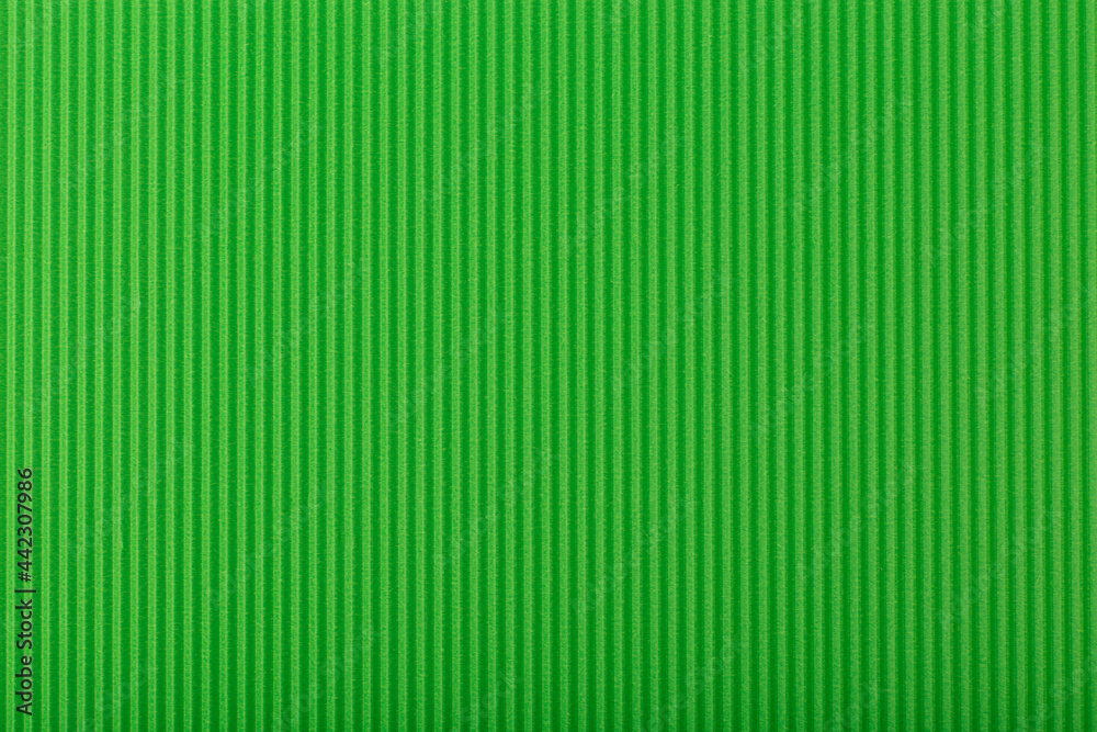 Abstract green background with vertical lines. Textured background with copy space. Corrugated paper top flat lay, concept of template for website or banner Abstract green background with vertical lines. Textured background with copy space. Corrugated paper top flat lay, concept of template for website or banner