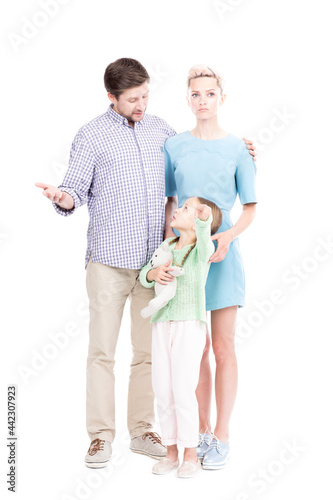 Wallpaper Mural Vertical full length shot of little Caucasian girl showing something to her parents pointing finger at camera, white background Torontodigital.ca