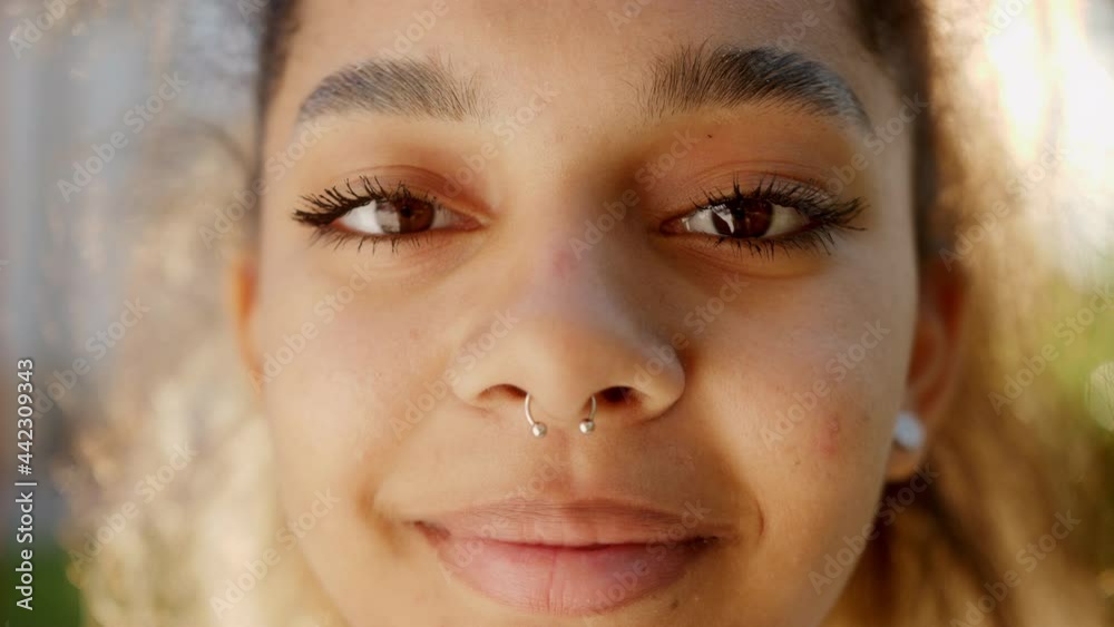 Close up portrait of smiling beautiful mixed race young woman looking up at camera. Close up portrait of smiling beautiful mixed race young woman looking up at camera.