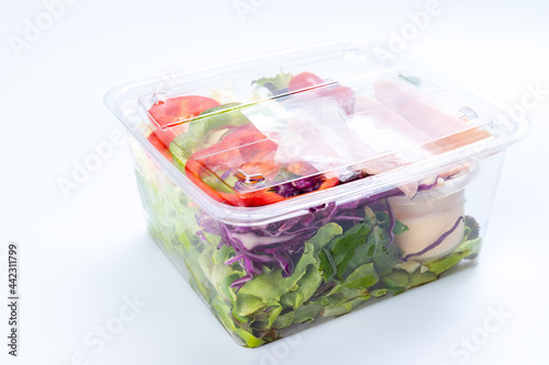 Vegetable salad in clear plastic box Ready-to-eat breakfast that is available for sale at the supermarket, convenience store, hypermarket Isolated white background. Healthy food concept, health care.