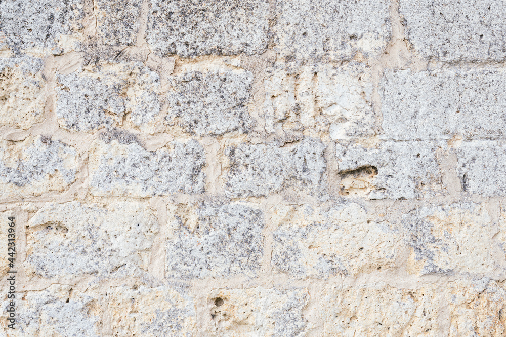 Textured background stone wall of a medieval castle Textured background stone wall of a medieval castle