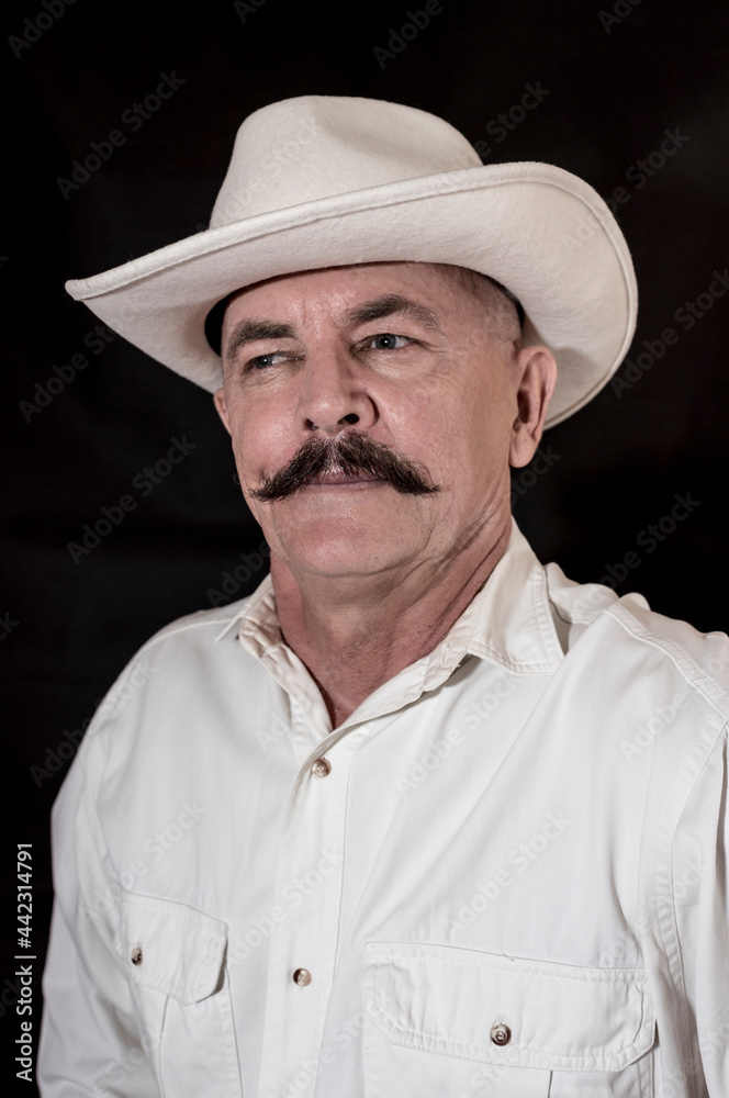 The cowboy with mustache in a white hat The cowboy with mustache in a white hat