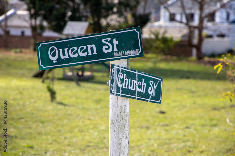 Street name signs with Queen St and Church St written on the signs Street name signs with Queen St and Church St written on the signs