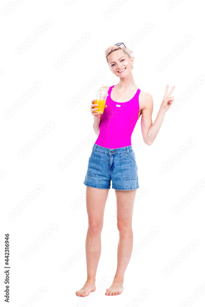Vertical full length studio portrait of modern young Caucasian woman wearing summer outfit drinking fresh orange juice, white background Vertical full length studio portrait of modern young Caucasian woman wearing summer outfit drinking fresh orange juice, white background
