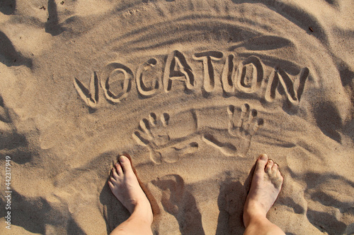 Sand on the beach and the inscription vacation photo