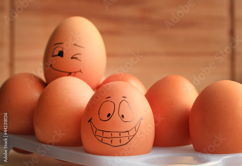 beige chicken eggs with a laughing face on an egg stand