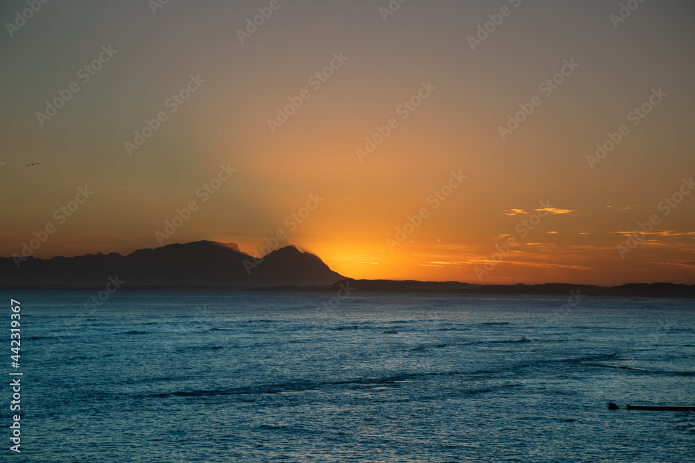 Sun set over the mountain and ocean