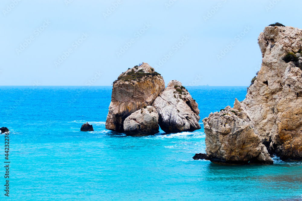 Lonely Island in Blue Sea with Rocks on the beach. Tourism destination, vacation location, Cyprus. Clear Water texture. Aerial view, sunny day over sea or ocean with birds.