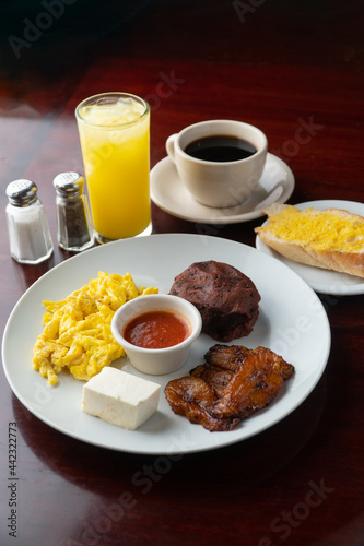 Typical Latin breakfast, ground beans, fried plantain and coffee 