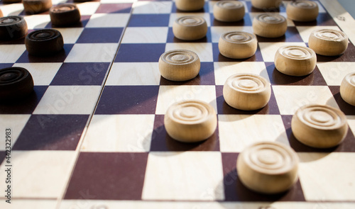 wooden chessboard with white checkers on a light surface. Mind games, mental development and strategy. Games for children and adults. Chess school
