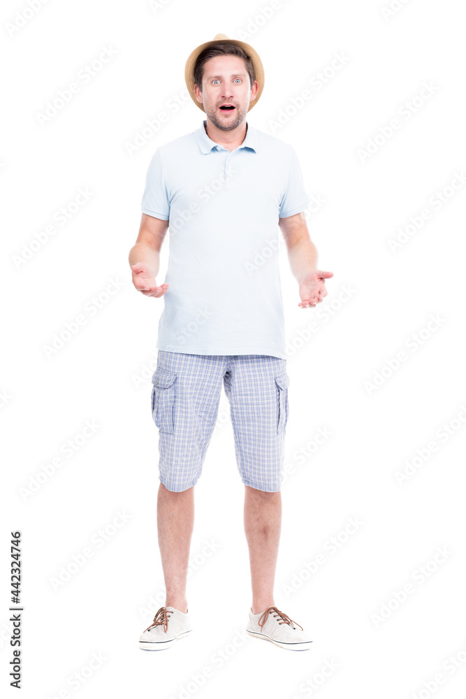 Vertical full length studio portrait of handsome bearded Caucasian man wearing summer outfit amused because of something, white background