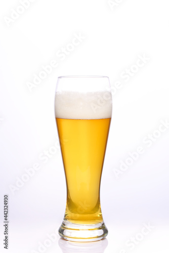 Glass of light beer on a white background.