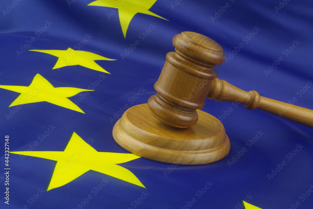 Judge gavel on waved  European Union flag. Laws, court and legal system in EU concept.